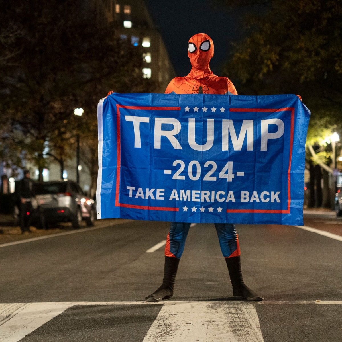 Trump-Unterstützer im Spider-Man-Kostüm mit einem Trump-Transparent am Tag der US-Präsidentschaftswahl 2024 in Washington. - Foto: Probal Rashid/ZUMA Press Wire/dpa