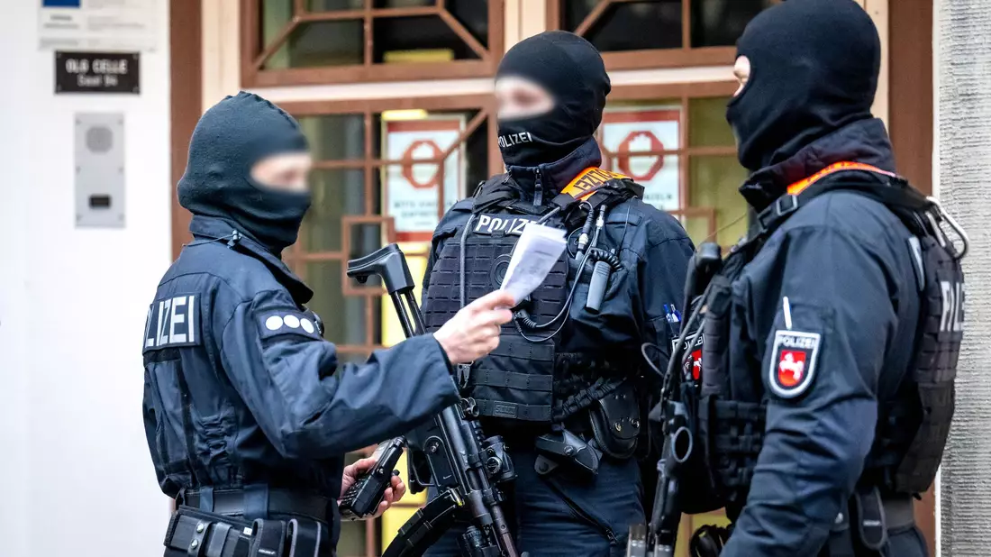 Bewaffnete Einsatzkräfte sicherten die Ankunft der Angeklagten. - Bild: Sina Schuldt/dpa