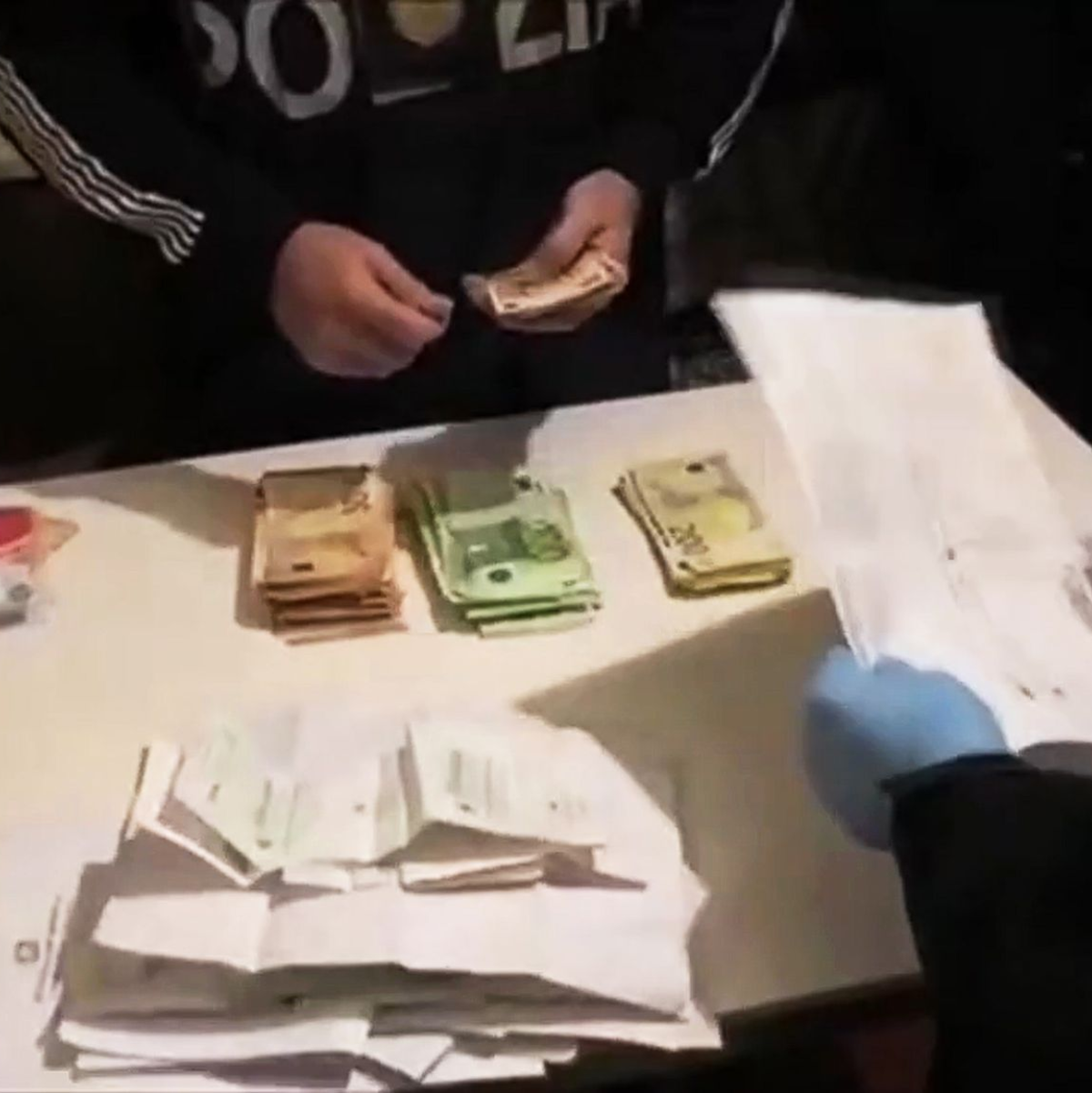 Es wurden unter anderem Geschäftsunterlagen und Bargeld sichergestellt. - Foto: -/Polizia di Stato/dpa