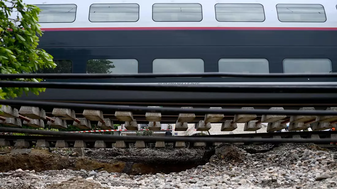 Dieser Zug musste anhalten, weil der Schotter unter den Schienen nach heftigen Regenfällen wegbrach. - Bild: Christophe Archambault/AFP/dpa