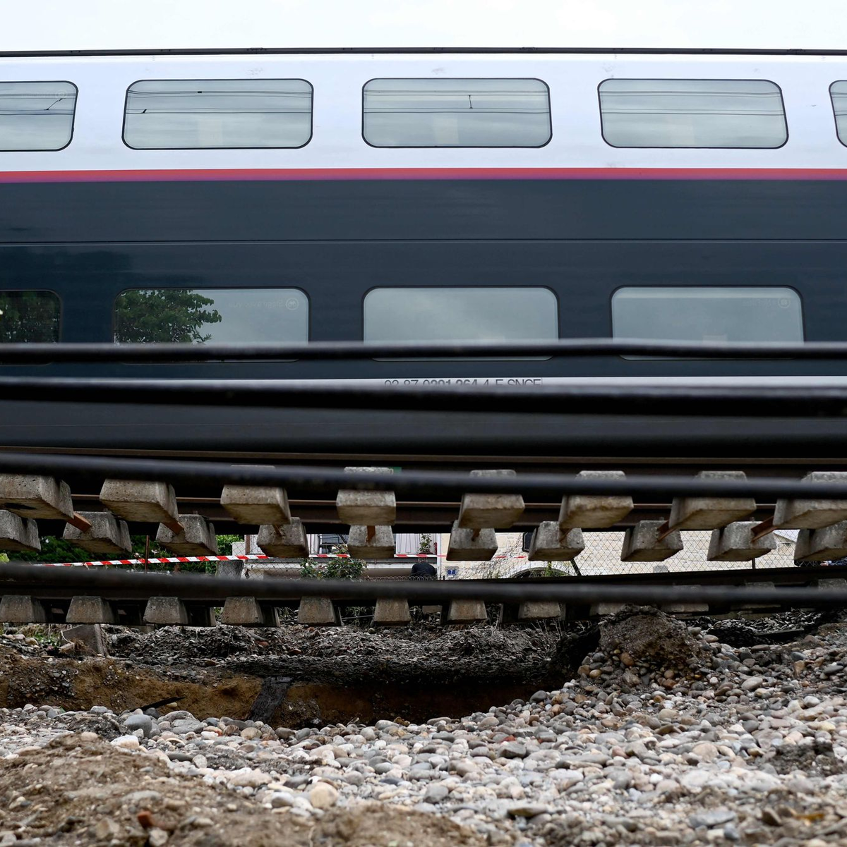 Dieser Zug musste anhalten, weil der Schotter unter den Schienen nach heftigen Regenfällen wegbrach. - Foto: Christophe Archambault/AFP/dpa