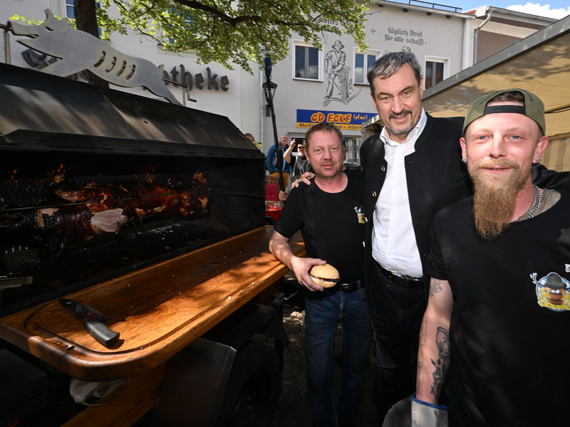 Ministerpräsident Söder am Schweinegrill.  - Foto: Felix Hörhager/dpa