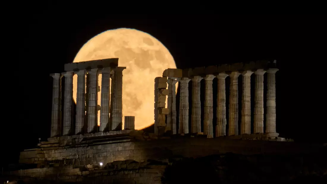 Der Erdbeermond geht in Griechenland hinter dem Poseidontempel am Kap Sounion auf. - Bild: Petros Giannakouris/AP/dpa