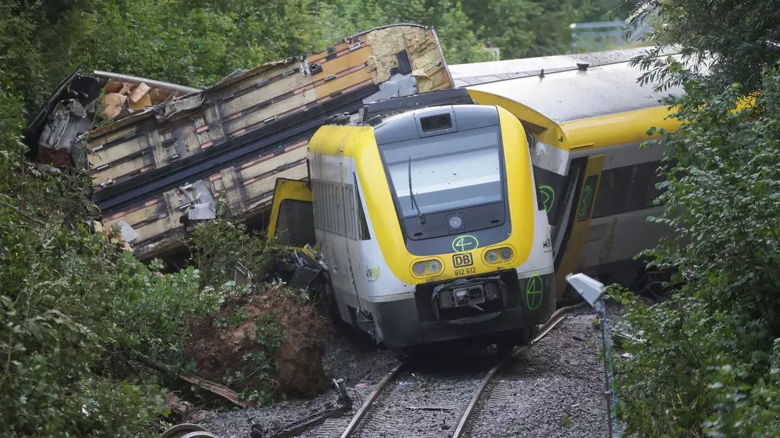 Mit einem Kran wurden am Montagabend die ersten Waggons des entgleisten Zugs geborgen.  - Bild: Thomas Warnack/dpa
