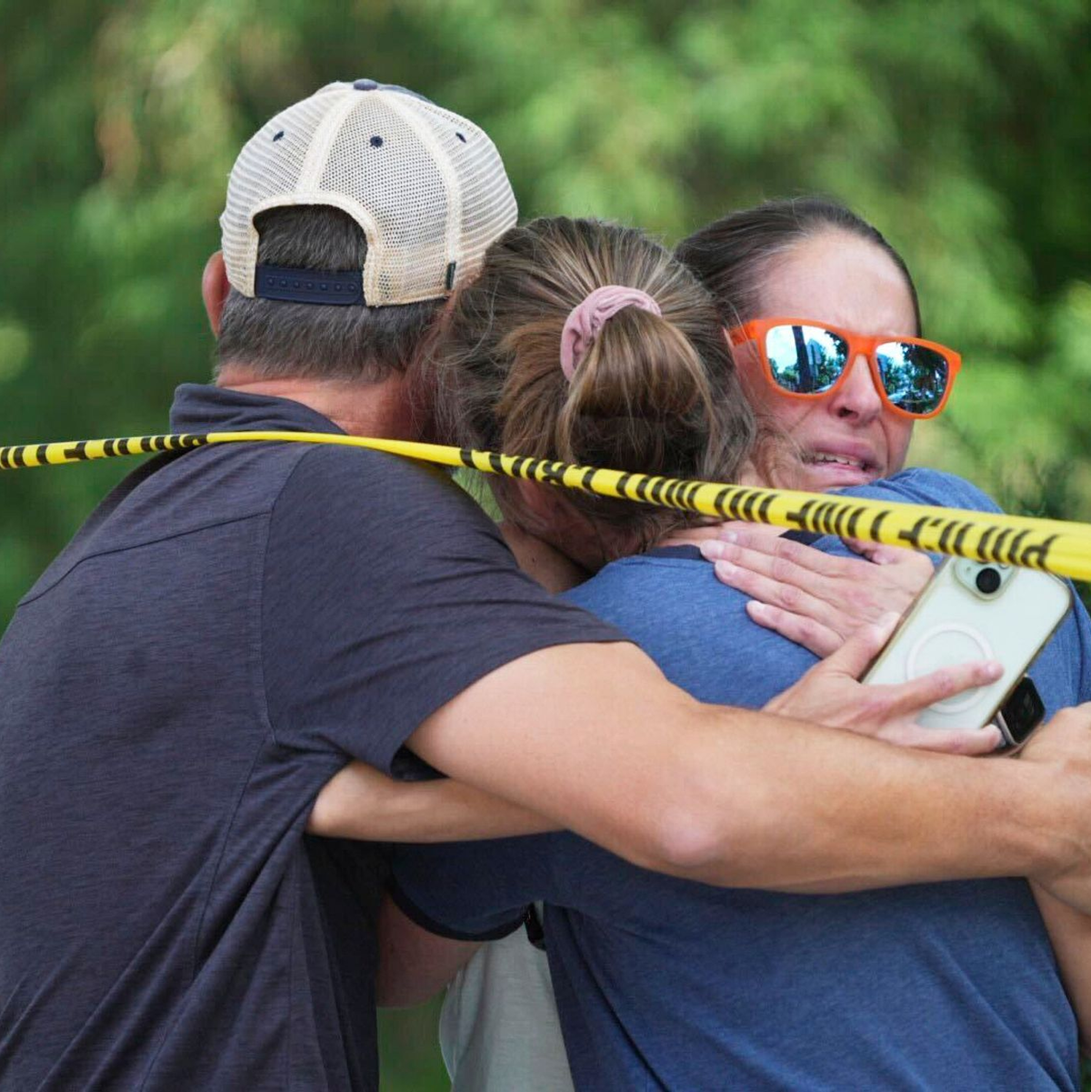 Menschen umarmen sich nach Schüssen an einer Schule, bei denen zwei Kinder gestorben sind. - Foto: Alex Kormann/Star Tribune/AP/dpa