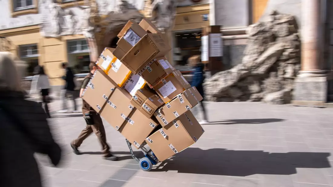 Ganz schön viel zu tun: ein Paketbote bei der Arbeit. - Bild: Peter Kneffel/dpa