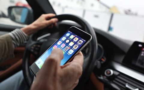 Ein «kurzer» Blick auf das Handy ist bisher erlaubt - wenn man es nicht in die Hand nimmt. (Symbolbild) - Foto: Karl-Josef Hildenbrand/dpa