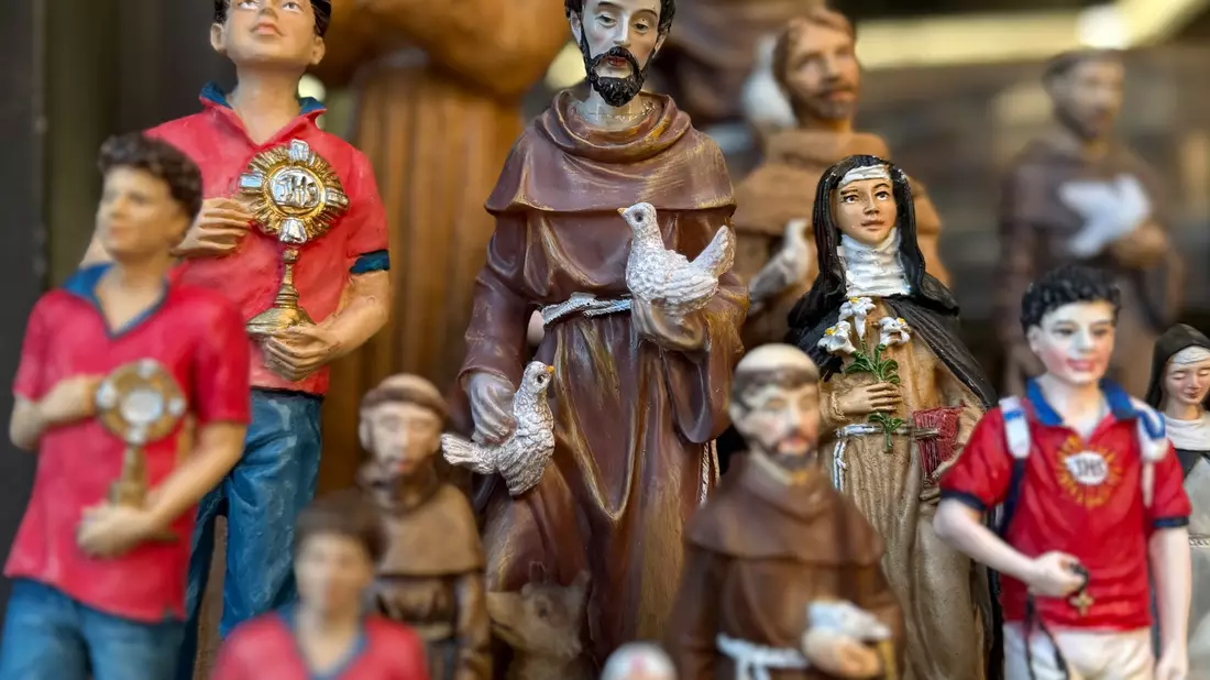 Figuren des alten und des neuen Heiligen stehen in Souvenirshops nebeneinander. (Archivbild) - Bild: Christoph Sator/dpa