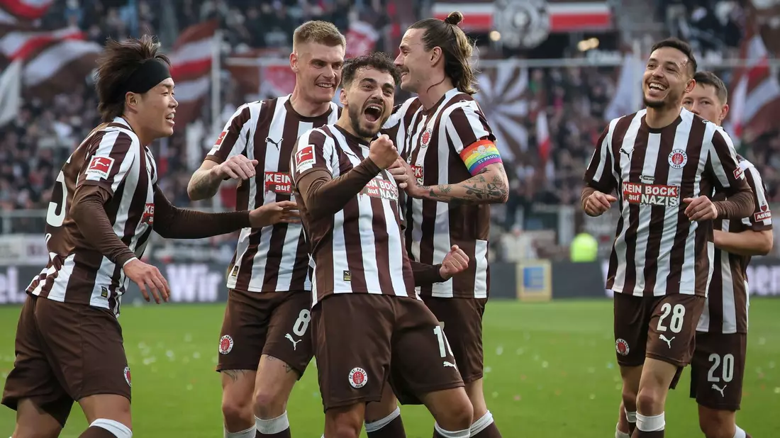 Umjubelter Torschütze: St. Paulis Danel Sinani (3.v.l.) nach seinem Tor zum 1:0 - Bild: Christian Charisius/dpa