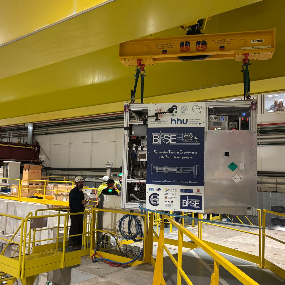 Im Schneckentempo wird der Transportcontainer am Kran durch die Antimaterie-Fabrik gebracht.  - Foto: Christiane Oelrich/dpa