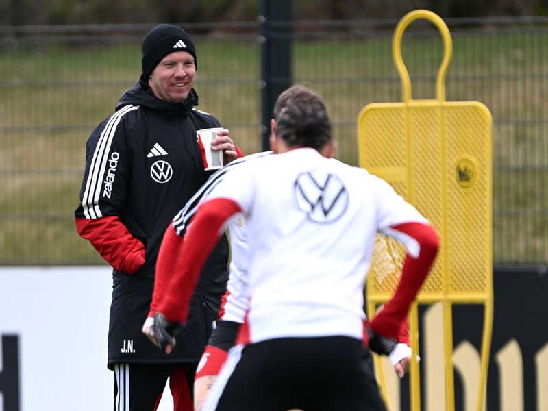Warm eingepackt verfolgt Bundestrainer Julian Nagelsmann das Geschehen auf dem Trainingsplatz. - Foto: Federico Gambarini/dpa