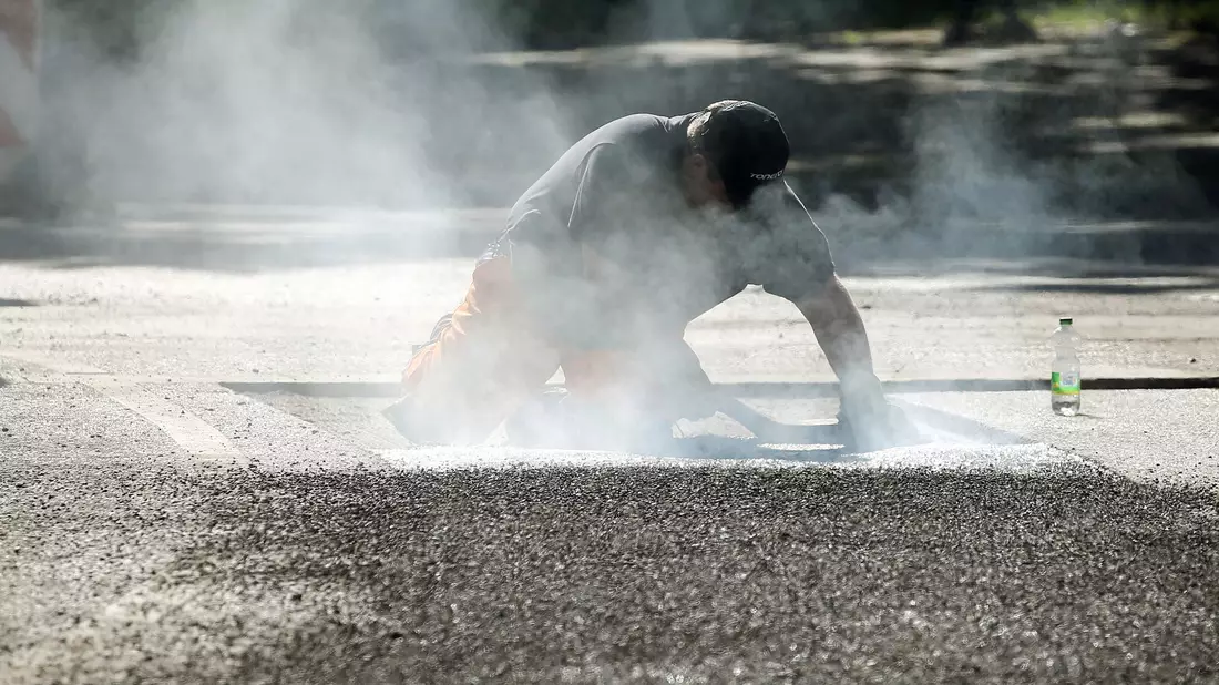 Ein Bauarbeiter repariert eine Straße in Berlin mit Bitumen, einem Bindemittel für Asphalt. (Symbolbild) - Bild: Wolfgang Kumm/dpa