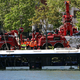 Der Linienbus wird von Kränen aus dem Fluss geborgen. - Foto: Thomas Samson/AFP/dpa