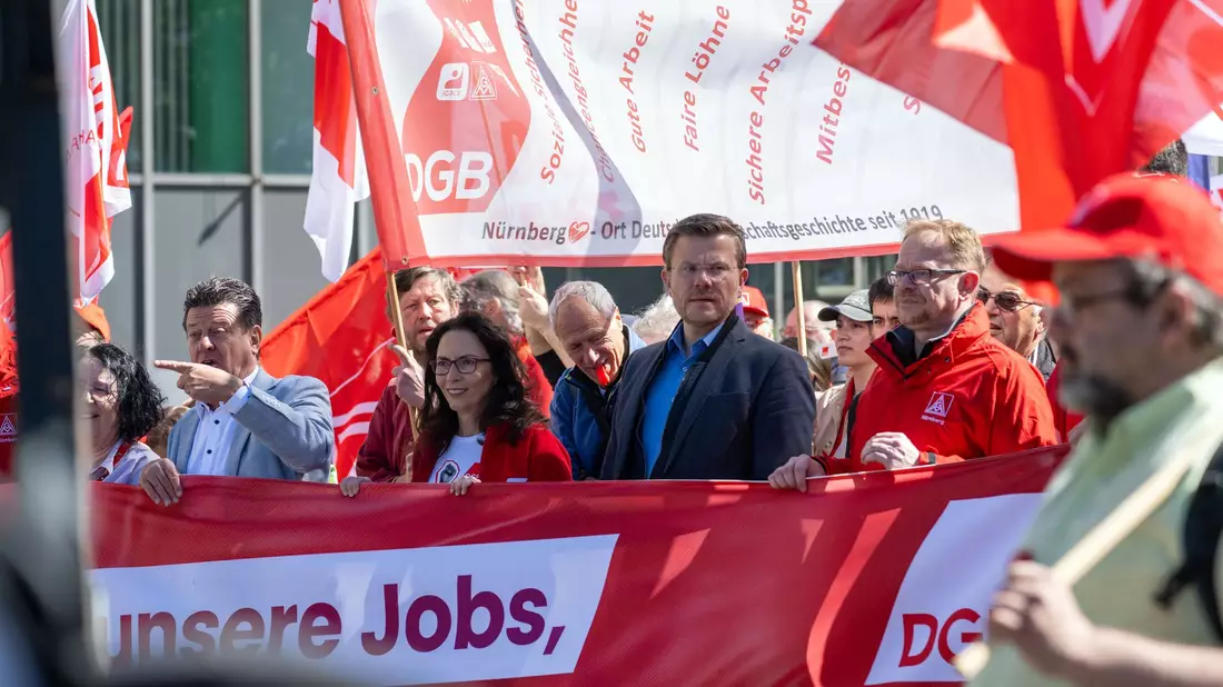Die DGB-Bundesvorsitzende Yasmin Fahimi (Mitte) bei der zentralen Maikundgebung der Gewerkschaften in Nürnberg. - Bild: Pia Bayer/dpa