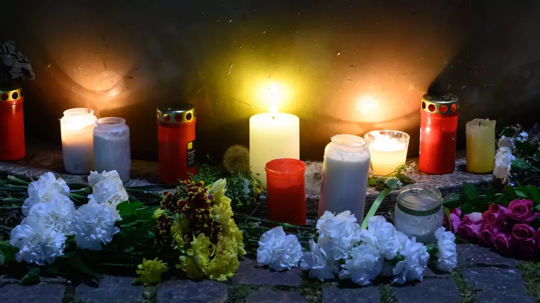 Am Tatort haben Menschen mit Blumen und Kerzen ihr Mitgefühl ausgedrückt. - Bild: Hendrik Schmidt/dpa