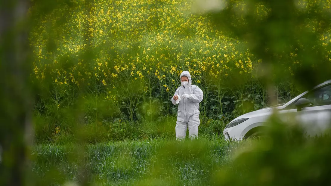 Eine Ermittlerin in weißem Ganzkörperanzug am Tatort. - Bild: Jason Tschepljakow/dpa