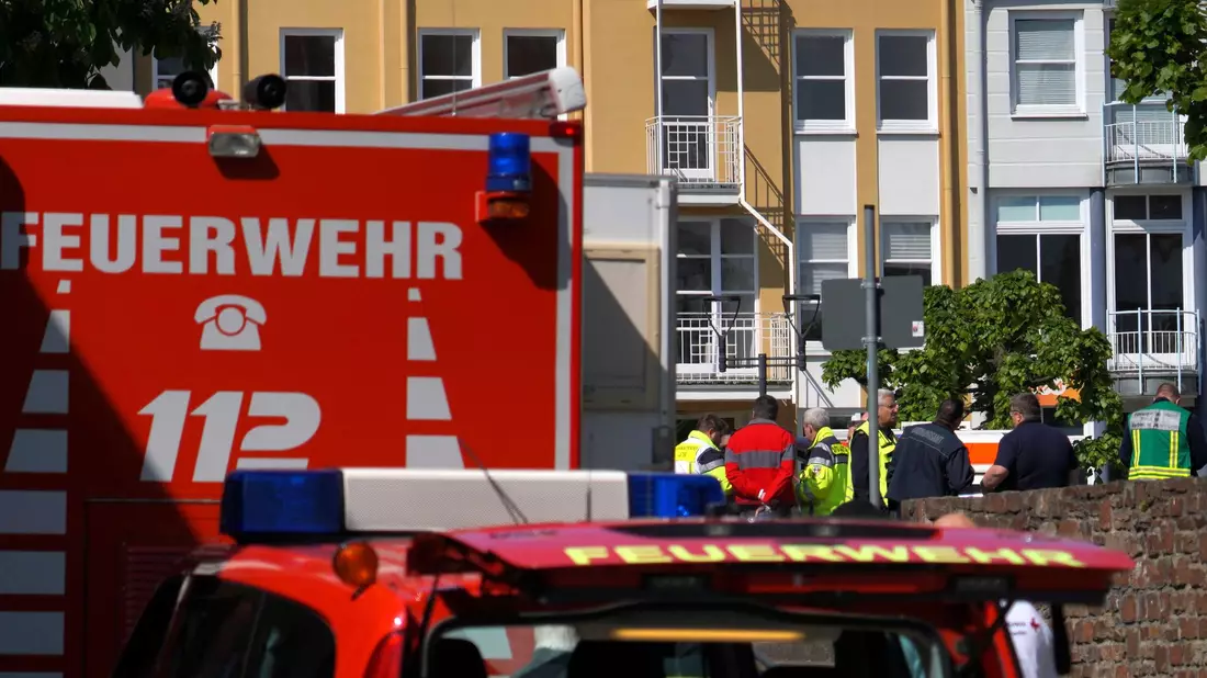 Rettungswagen, Polizisten und Polizeifahrzeuge stehen in der Nähe des Einsatzortes. - Bild: Sascha Ditscher/dpa