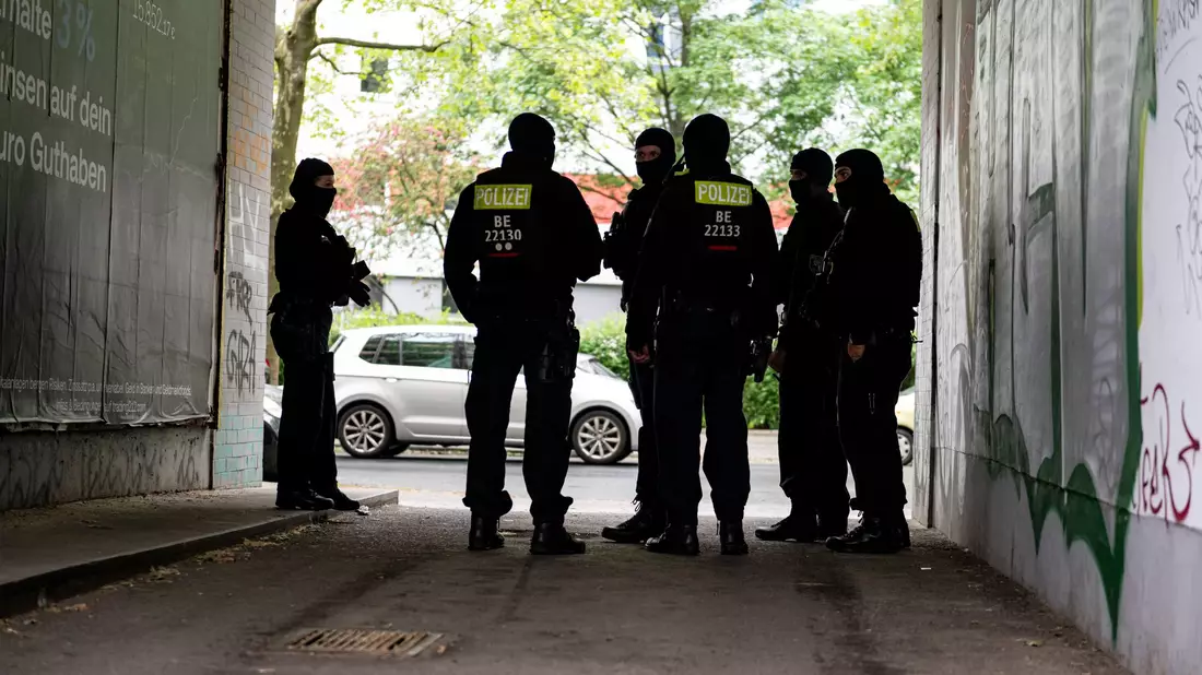 Die Polizei in Berlin durchsucht zahlreiche Wohnungen und nimmt Verdächtige fest wegen Erpressung, illegalen Waffenbesitzes und Bandenkriminalität.  - Bild: Fabian Sommer/dpa