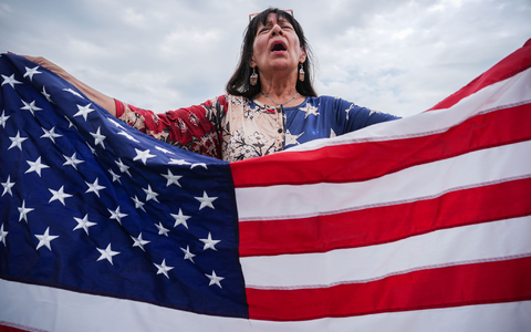 Viele Teilnehmer haben US-Flaggen bei sich.  - Foto: Julia Demaree Nikhinson/AP/dpa