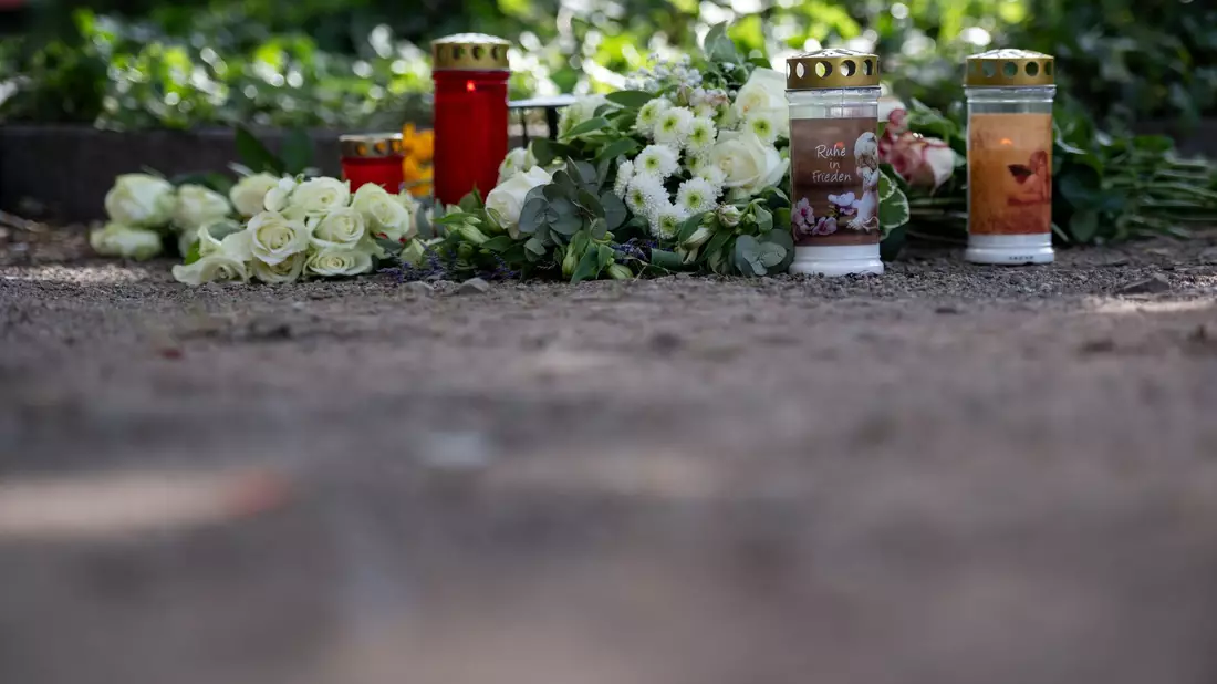 Nahe der Unfallstelle wurden am Nachmittag Kerzen aufgestellt und Blumen niedergelegt.  - Bild: Fabian Strauch/dpa