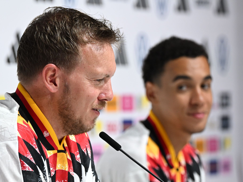 Julian Nagelsmann (l.) und Jamal Musiala (r.) sprechen bei der DFB-Pressekonferenz.  - Foto: Federico Gambarini/dpa