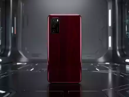 A close-up of a sleek smartphone with a dark cherry finish, reflecting light, against a blurred, high-tech background. - Foto: über boerse-global.de