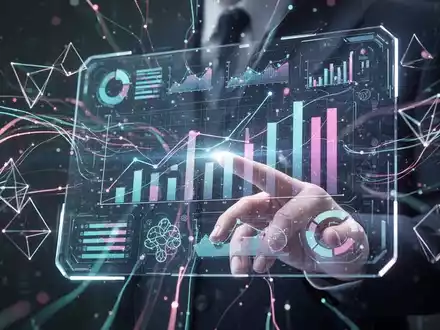A stylized human hand interacts with a holographic screen displaying business graphs and creative design elements, symbolizing AI and data flow. - Foto: über boerse-global.de