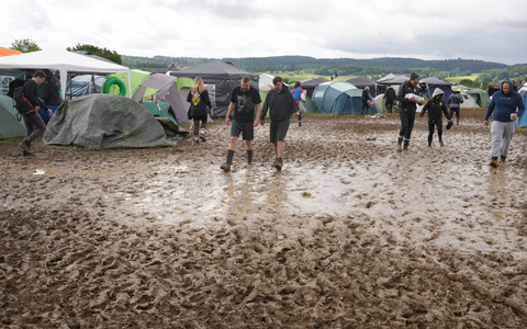 Viele Camper setzen bei Rock am Ring auf Gummistiefel, um trockene Füße zu behalten.  - Bild: Thomas Frey/dpa