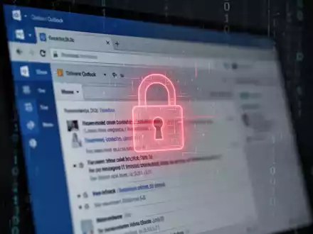 A close-up of a computer screen showing a blurred Outlook email interface with a red glowing digital lock icon, suggesting a security vulnerability. - Foto: über boerse-global.de