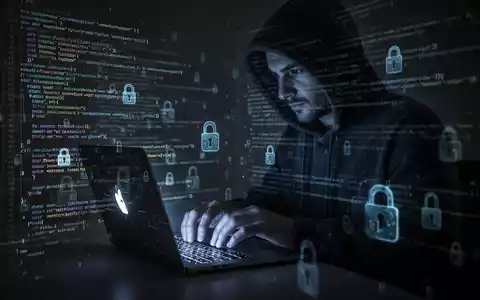 A person in a hoodie typing on a laptop, surrounded by digital security symbols, representing cybersecurity vulnerabilities. - Foto: über boerse-global.de