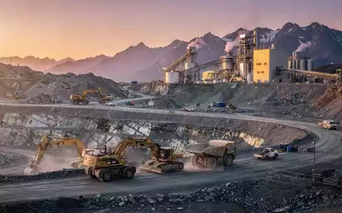 Eine moderne Silbermine in einer bergigen Landschaft bei Sonnenaufgang mit schweren Maschinen und einer Verarbeitungsanlage. - Foto: über boerse-global.de
