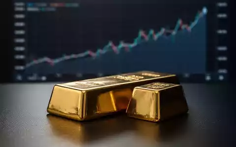 Ein glänzender Goldbarren auf dunklem Untergrund, im Hintergrund eine verschwommene Grafik mit Aufwärtstrend. - Foto: über boerse-global.de