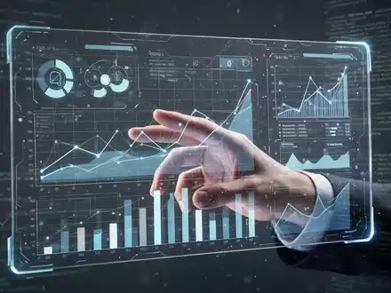 A hand interacting with a futuristic spreadsheet interface displaying data visualizations and AI elements. - Foto: über boerse-global.de