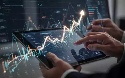 Finanzdiagramm mit aufsteigendem Trend, digitaler Benutzeroberfläche und Händen, die mit einem Tablet interagieren. - Foto: über boerse-global.de