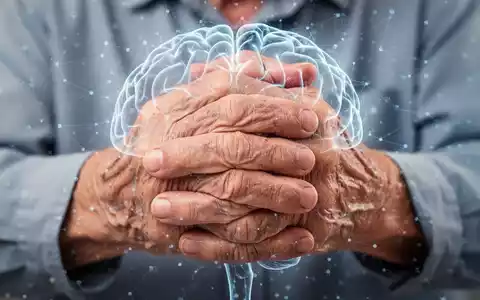 Nahaufnahme der Hände einer älteren Person, die die Gelenke reibt, mit einer dezenten grafischen Überlagerung eines Gehirns. Symbolisiert psychische Belastung bei Arthrose. - Foto: über boerse-global.de
