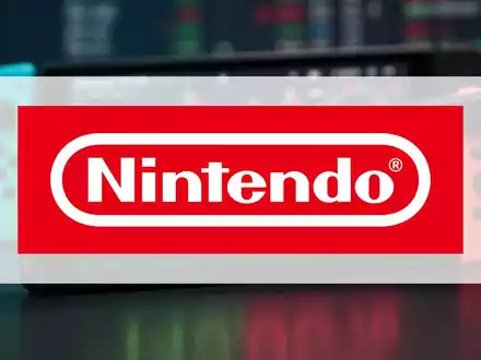 Ein Börsenticker zeigt einen negativen Prozentsatz, im Hintergrund eine unscharfe Nintendo Switch Konsole. - Foto: über boerse-global.de