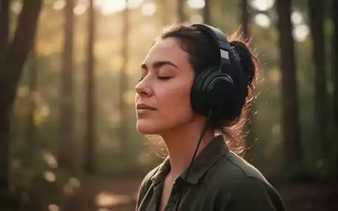 Eine Person mit Kopfhörern, die entspannt und mit geschlossenen Augen Musik hört, in einer ruhigen, natürlichen Umgebung. - Foto: über boerse-global.de