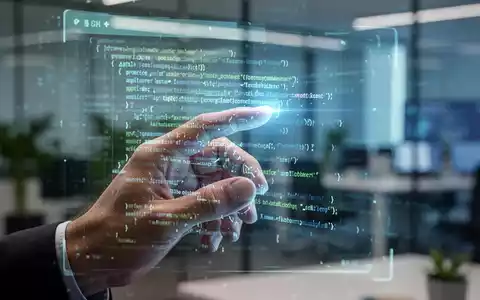Eine Hand interagiert mit einem leuchtenden, holografischen Interface, das Codezeilen anzeigt, im Hintergrund ein unscharfes Büro. - Foto: über boerse-global.de