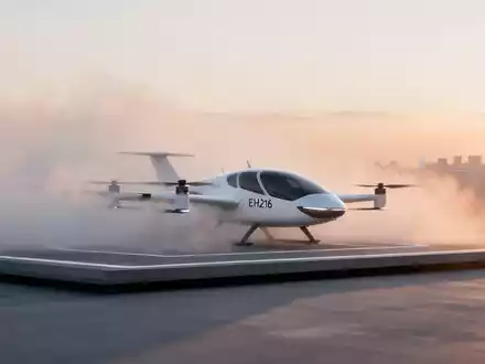 Ein elegantes, futuristisches weißes EHang EH216 eVTOL-Flugzeug auf einem Landeplatz vor einer verschwommenen Stadtsilhouette. - Foto: über boerse-global.de