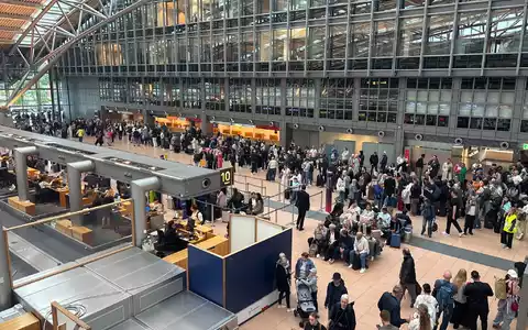 Zahlreiche Menschen stehen im Terminal des Hamburger Flughafens. - Foto: Frank Molter/dpa