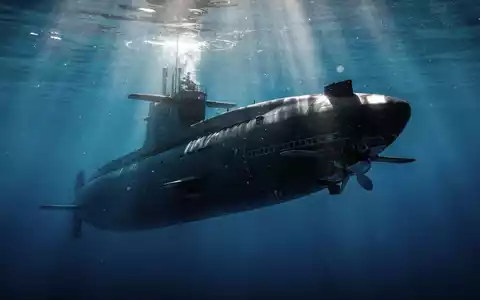 Ein modernes U-Boot gleitet unter Wasser, mit Sonnenlicht, das durch die Oberfläche bricht. - Foto: über boerse-global.de