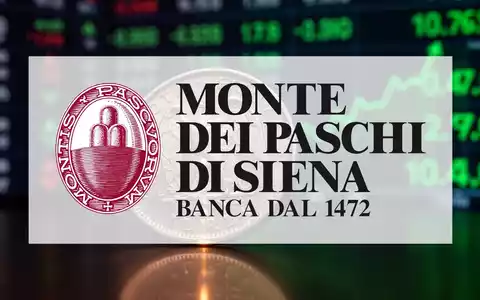 Nahaufnahme einer alten italienischen Münze, die ein leichtes Leuchten reflektiert, mit einem unscharfen Börsenticker im Hintergrund. - Foto: über boerse-global.de