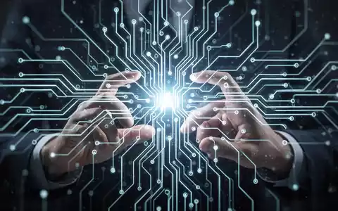 Stylized image of a glowing neural network with hands interacting with a digital interface, symbolizing AI education and technological development. - Foto: über boerse-global.de