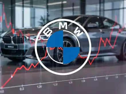 Eine rote Linie auf einem digitalen Börsenchart, die einen Jahrestiefststand erreicht, mit einem verschwommenen BMW im Hintergrund. - Foto: über boerse-global.de