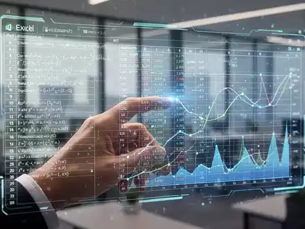 A hand interacting with a holographic Excel spreadsheet displaying advanced data functions and charts in a modern office. - Foto: über boerse-global.de
