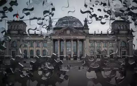 Das Reichstagsgebäude, teilweise verdeckt von abstrakten, ineinandergreifenden Zahnrädern, die Föderalismus und Finanzreform symbolisieren. - Foto: über boerse-global.de