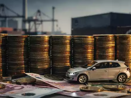 Ein stilisiertes Bild von Euro-Münzen, die eine Barriere bilden, vor einem kleinen Volkswagen-Modell. Industrieller Hintergrund. - Foto: über boerse-global.de
