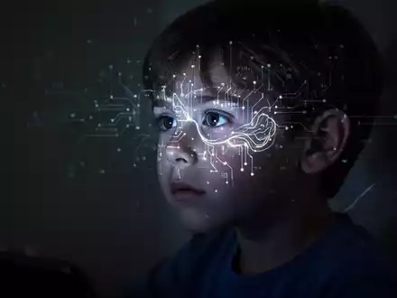 Silhouette eines Kindes, dessen Gesicht von einem digitalen Bildschirm beleuchtet wird, mit angedeuteter Gehirnaktivität. - Foto: über boerse-global.de