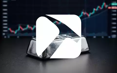 Ein glänzender Silberbarren auf dunklem Untergrund, mit einem unscharfen, aufsteigenden Börsenchart im Hintergrund. - Foto: über boerse-global.de