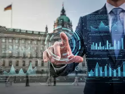 A hand interacts with a holographic interface displaying data and German text, symbolizing digital transformation challenges in public administration. - Foto: über boerse-global.de